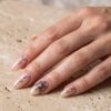 Metatron's Cube sacred geometry nail art on minimalist neutral almond nails