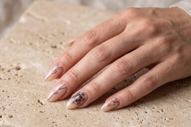 Metatron's Cube sacred geometry nail art on minimalist neutral almond nails