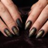 Matte black and gold Illuminati Eye of Providence nail art with pyramid design