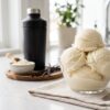 Ninja Creami protein ice cream in a bowl with vanilla protein powder and ingredients