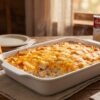 Cheesy chicken and rice dump and bake casserole with melted cheddar in a 9x13 baking dish.