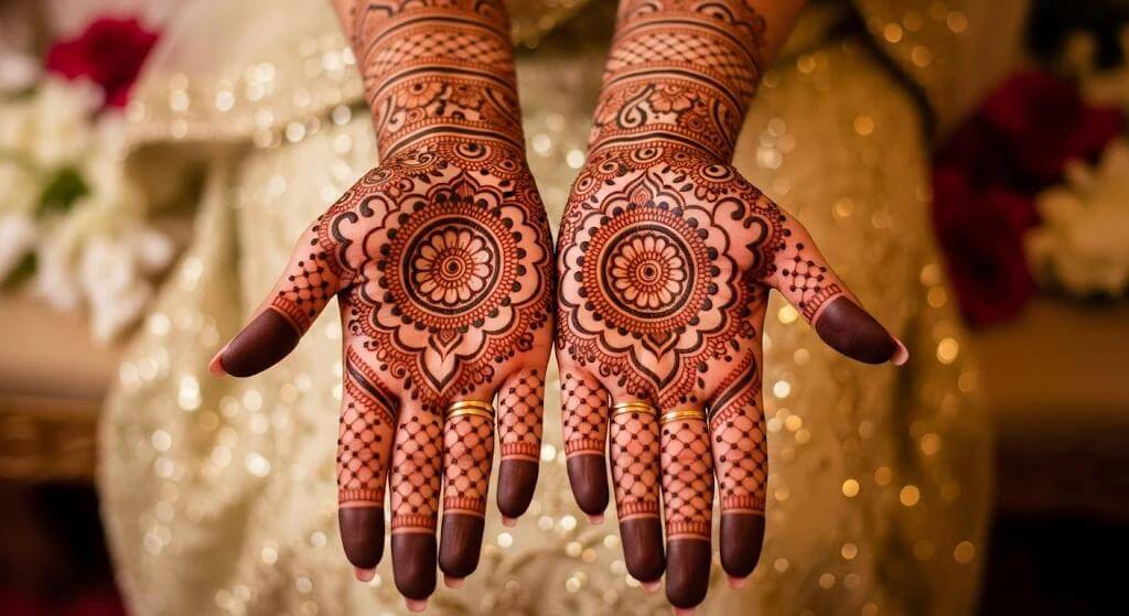 Intricate bridal mehndi designs featuring floral mandalas, paisley patterns, and detailed henna artwork across both hands.