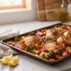 15-minute sheet pan dinner with roasted chicken, broccoli, peppers, red onion, and cherry tomatoes on one baking sheet